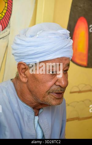 Luxor, Egypt - October 08, 2021: Portrait of an elderly Arab man in a turban and national clothes. Close-up. Stock Photo