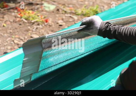 Selective focus heat shield That was attached to a new galvanized sheet bought from a building supply store. For installation on the roof of a car rep Stock Photo