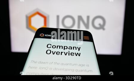 In this photo illustration, a mobile phone with the website of US quantum computing company IonQ Inc. is seen on screen in front of logo. Stock Photo