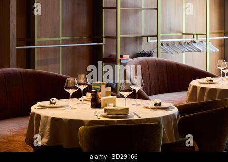 Elegant dining setup in a modern restaurant with cozy seating Stock Photo