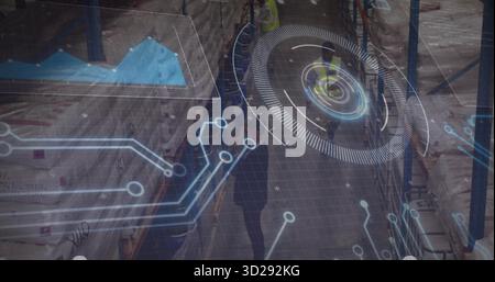 Scanning helmeted safety vest worker checking stock using holograms in storage aisle with pallets Stock Photo