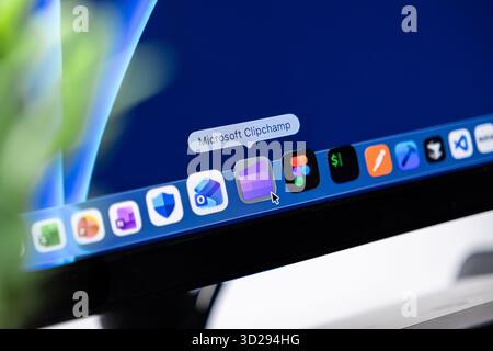 Poznan, Poland - October 16, 2025: Microsoft Clipchamp application icon with a mouse cursor pointing to it on a laptop screen dock, displaying video e Stock Photo
