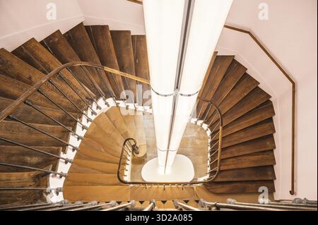 The historic wooden spiral staircase (Escalier), photographed under supervision with central, modern lighting, is located in the former bishop's palac Stock Photo