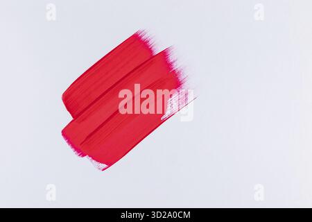 Three parallel strokes with red acrylic paint on a white background. abstract artistic background in minimalism of artistic style Stock Photo