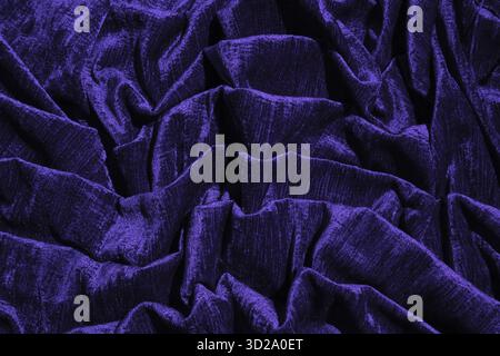 Abstract mystical background in dark blue. chic soft folds of factory velvet fabric. Luxury interior fabric for design. future dusk Stock Photo