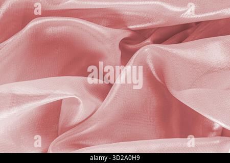 Abstract background silk, chiffon texture fabric pink, coral color. soft waves of delicate fabric. airy drapery. layout for design Stock Photo