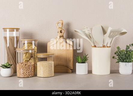 Kitchen background. A set of kitchen utensils and various utensils for cooking on a stone kitchen countertop. Front view. Eco-friendly cuisine Stock Photo