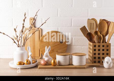 Eco-friendly kitchen utensils, wooden cutting boards, vase with willow twigs, Easter decorations. Eco style. Front view Stock Photo