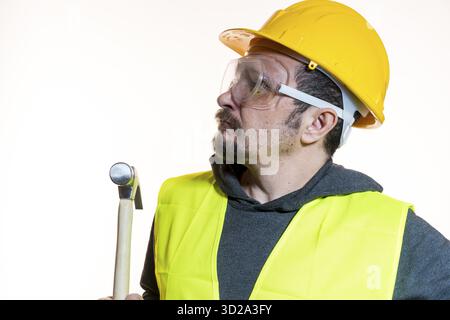 Do it yourself, man dressed in yellow builder helmet with protective glasses ready to start the construction work Stock Photo
