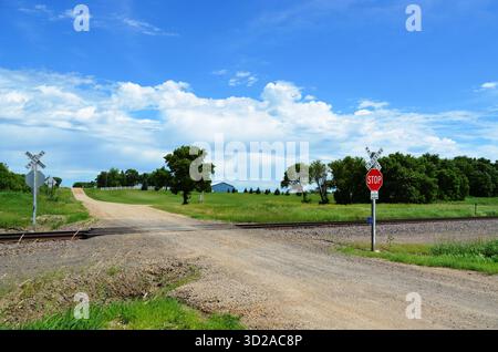 Rural unimproved natural beauty road and railroad tracks at a minimally controlled intersection make for a dangerous situation. Stock Photo