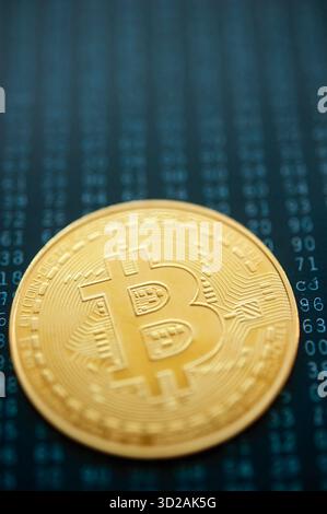 Golden Bitcoin coin on binary code background symbolizing digital cryptocurrency and blockchain technology Stock Photo