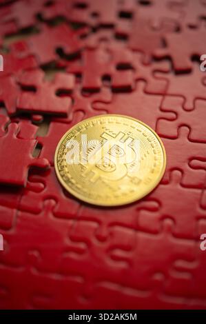 Bitcoin coin on red puzzle pieces representing connection, challenge, and cryptocurrency integration concept Stock Photo