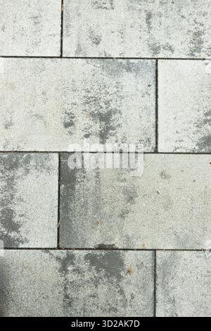 Grey stone pavement texture with irregular weathered patterns useful for background or design use Stock Photo