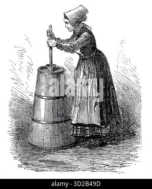 Woman making butter with butter churn. Old traditional method making of ...