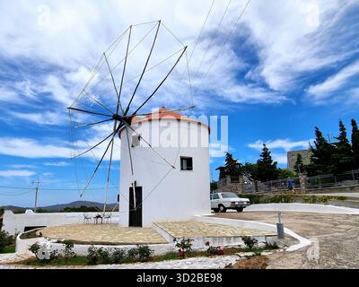 A typical Greek landscape with a windmill against a beautiful sky in Sigri, Lesbos, Greece. Stock Photo