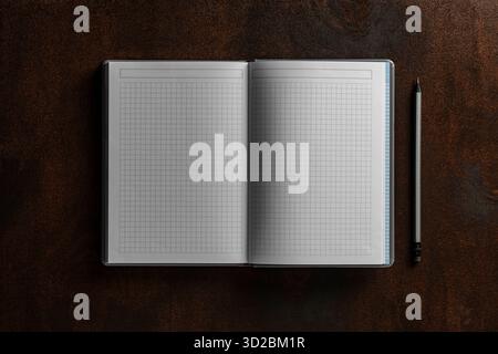 Open notebook with checkered sheets and pencil on wooden texture background, close up, top view, copy space Stock Photo