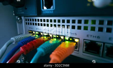Colorful ethernet cables connected to network switch, symbolizing high speed data transfer, secure communication, and modern information technology co Stock Photo