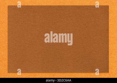 Textured brown paper background with orange border. Vintage kraft cardboard with empty frame. Banner with copy space. Stock Photo