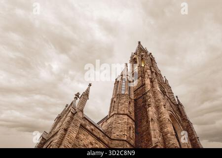 Low angle view of St. Louis Roman Catholic Church, low angle view against dramatic cloudy sky, Buffalo, New York, USA Stock Photo