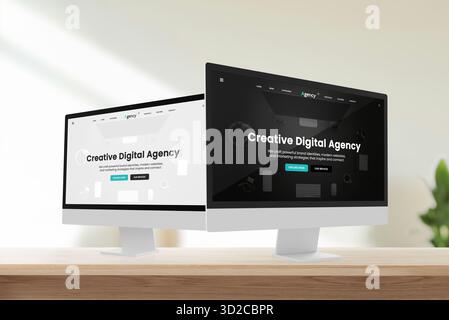 Two computer screens side by side showing dark and white versions of creative digital agency website design in bright modern office Stock Photo