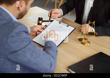 Business people review contract, lawyer and client discuss legal agreement Stock Photo