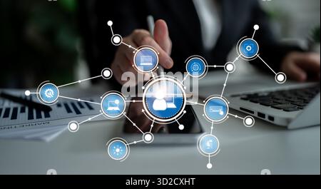 A business professional uses a digital interface to connect various devices, enhancing collaboration and productivity through advanced technology and Stock Photo