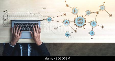 Conceptual image showing hands typing on a laptop with digital icons representing connectivity and business networking illustrating modern work enviro Stock Photo