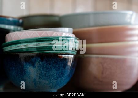 Dishes on the shelf, a stack of clean plates and bowls. Stock Photo