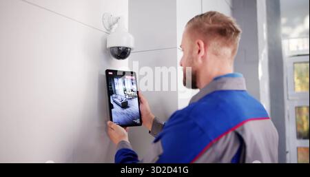 Security Technician Installing CCTV Surveillance System For Video Alarm Services. Stock Photo