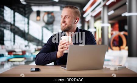 Young Executive Enjoying Breakfast Meeting In Luxury Hotel Lobby Stock Photo