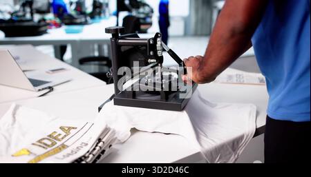 Black Business Owner Designs Custom African Print Shirt For Workshop Stock Photo
