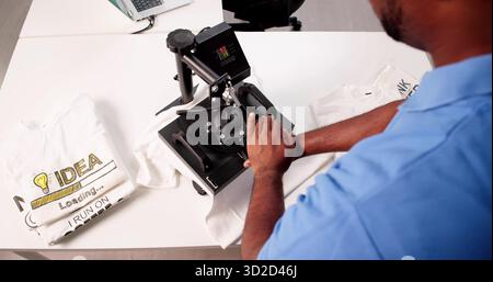 Creating Custom T-shirt Designs Using Heat Press And Screen Transfer. Possible Professions: Graphic Designer Stock Photo
