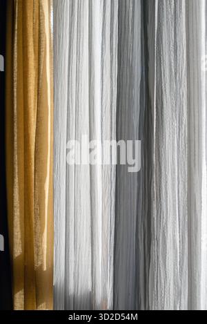 A metallic gold curtain texture with vertical folds, warm reflective ...