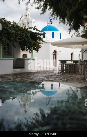 St. Nicholas Church in the old town of Antiparos reflected in a puddle, Cyclades, Greece Stock Photo