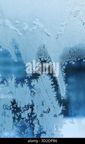 Beautiful ice pattern close-up on winter window glass, nature texture Stock Photo