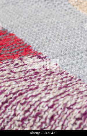 Traditional handmade wool patchwork knitted crochet blanket. Keeping warm in winter concept Stock Photo