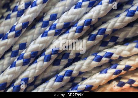 Close up view of strong blue and white braided nylon rope texture. durable cord showing detailed pattern, perfect for nautical or utility backgrounds Stock Photo