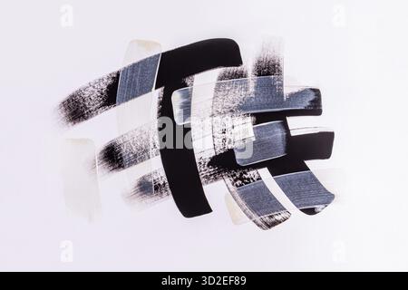 Beautiful black, gray brush strokes of acrylic paint on a white background. Abstract paint texture background. The concept of artistic design Stock Photo