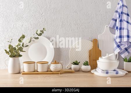 Beautiful kitchen background with various kitchen utensils, textiles for the kitchen. wooden table top, gray textured background with space for text Stock Photo