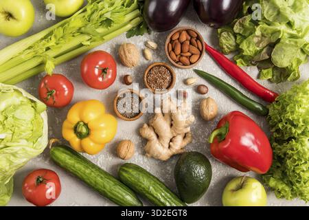 Vegetable food background. an assortment of fresh vegetables, fruits, nuts, seeds on a gray table. A healthy diet. Vitamins Stock Photo