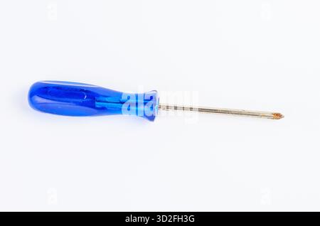 Close-up of an old Phillips screwdriver with a worn blue handle on a clean white background. Ideal for tools, repair, and DIY concepts. Stock Photo