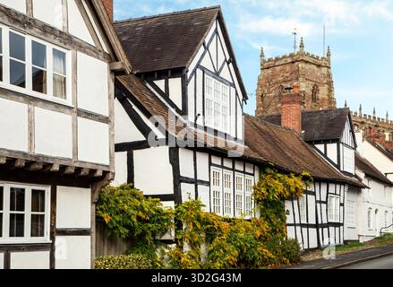 South Cheshire market town of Malpas, with black and white half timbered houses along church street and St Oswald's parish church in the background Stock Photo