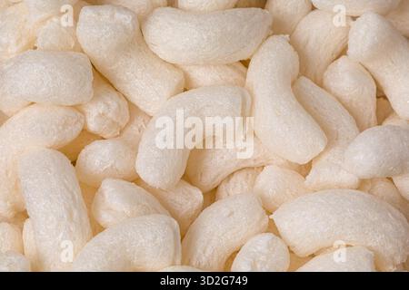 Closeup of foam packing peanuts. Shipping peanuts recycling, disposal and biodegradable packaging material concept. Stock Photo