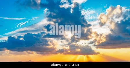 Dramatic Sunset Sky with Cloudscape and God Rays over the Horizon Stock Photo