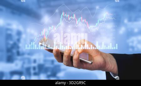 Close-up of a person holding a smartphone showing financial graphs and data, symbolizing investment trends and analytics in a modern office setting. S Stock Photo