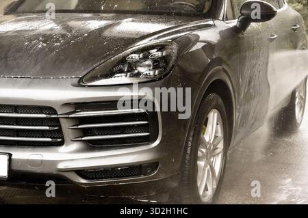 car in a heavy rain on a rainy day, closeup of photo Stock Photo