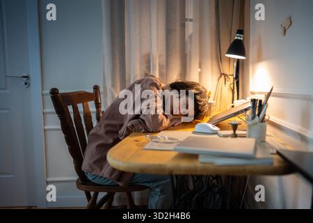 Exhausted burned out woman resting head on hands. Tired female working late night desk with stress Stock Photo