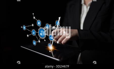 A business professional uses a stylus on a tablet, engaging with a digital interface. This image highlights technology and innovation, enhancing moder Stock Photo
