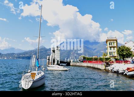 Panoramic View of Varenna Bay on Lake Como, Italy, with Moored Boats on a Sunny Autumn Day Stock Photo