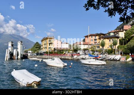 Panoramic View of Varenna Bay on Lake Como, Italy, with Moored Boats on a Sunny Autumn Day Stock Photo